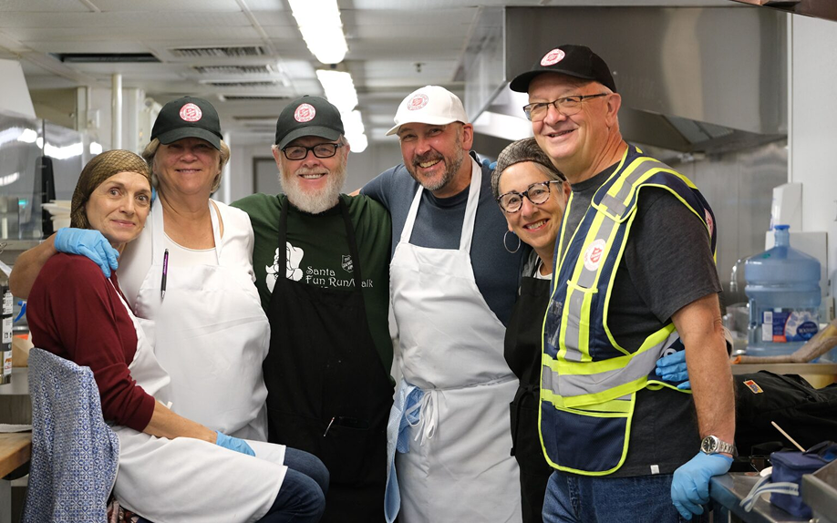 Volunteers smiling in the kitchen